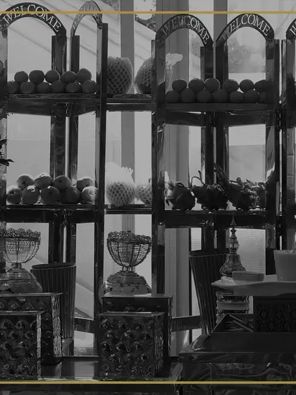 A black and white shot highlighting the structure and form of our fruit display stands. The multi-tiered setup creates an impressive tower of fresh produce for guests to enjoy.