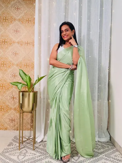 This pastel green satin ready-to-wear saree is so chic and sophisticated. It's a perfect choice for a cocktail party or a formal dinner.
