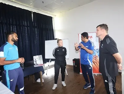 We believe in collaborative learning. This image shows an interactive discussion between coaches at the FIFA development event, sharing insights and strategies.