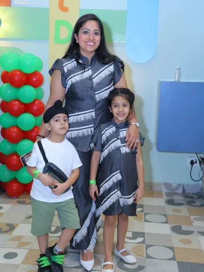 A mother and her two children dressed in matching outfits, a perfect photo opportunity.