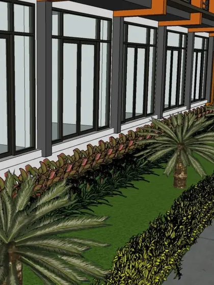 Another perspective of the commercial landscape design, illustrating how the greenery complements the modern architecture with its large glass windows.