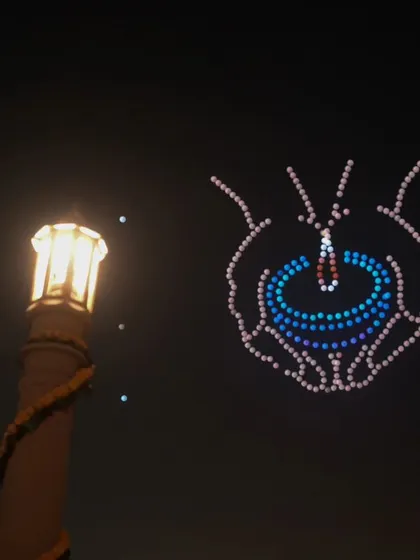 A diya held in protective hands, symbolizing the preservation of light and tradition. This was one of the many moving formations from our show at Delhi's Vasudev Ghat.