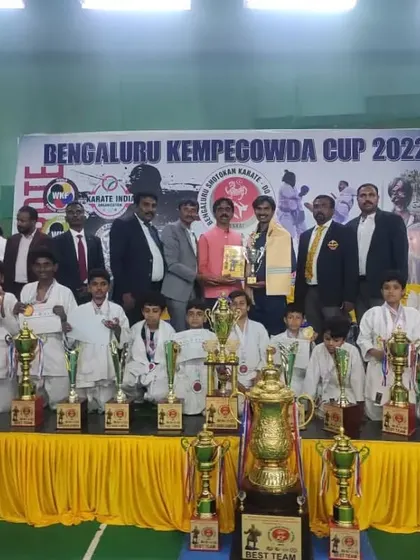 The entire team on stage with a massive haul of trophies and medals from the Bengaluru Kempegowda Cup 2022.