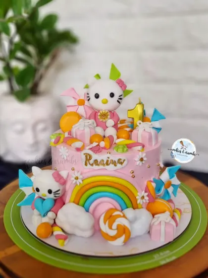 A super colorful and fun Hello Kitty themed cake for a first month birthday. It's loaded with handmade fondant details like rainbows, gift boxes, and of course, Hello Kitty herself.