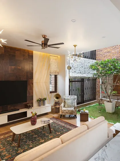 This living room in our Twin Courtyard House directly overlooks the internal green space. The design allows the family to enjoy the feeling of being outdoors while being comfortably inside, perfect for Bangalore's pleasant weather.