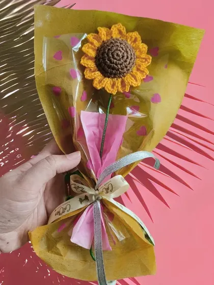 Another look at our cheerful sunflower bouquet, wrapped with a touch of pink for a pop of color.