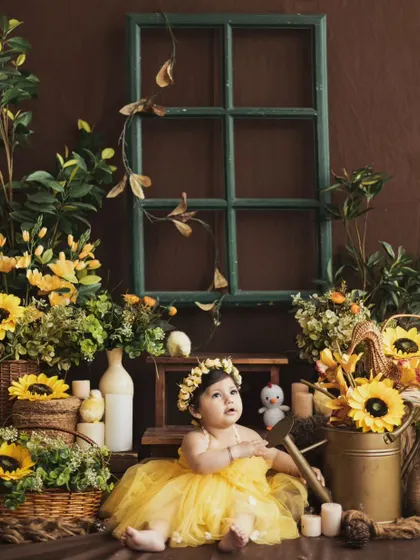 A curious glance from our little sunflower. The rustic props and warm lighting create a beautiful, earthy feel for this baby photoshoot.