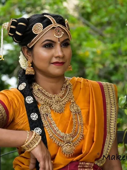 A portrait of a stunning Brahmin bride. The intricate details of her hair and makeup are designed to honor tradition while making her feel like the most beautiful version of herself.