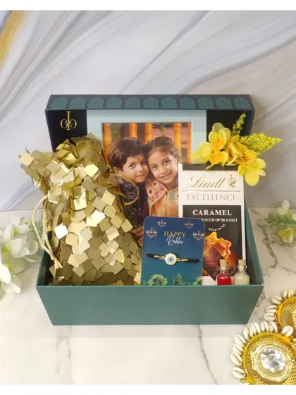 Make Rakhi memorable with a personalized hamper. This one includes a photo frame to capture a special memory, along with Lindt chocolate, a rakhi, and other festive essentials in a beautiful green box.