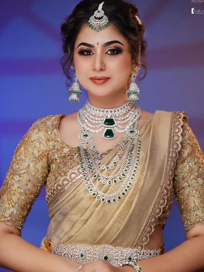 A frontal view showcasing the stunning multi-layered necklace and how the makeup highlights the bride's features.