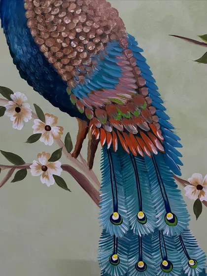A detail shot of the peacock's body and the delicate flowers.