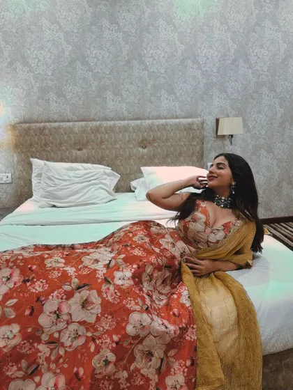 A client looking glamorous in a floral print lehenga.