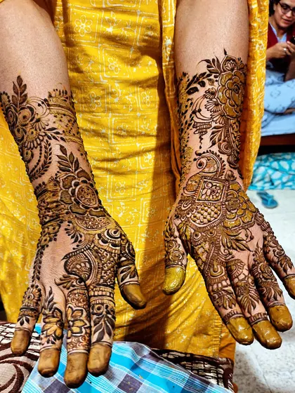 This design features a prominent peacock figure on one hand and floral vines on the other, showcasing artistic variety.