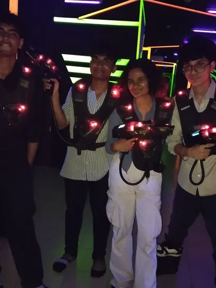 A group of young friends posing with their laser tag gear, ready for some fun.