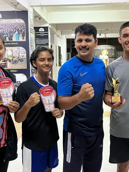 Our coach celebrating with some of our top youth performers. We take immense pride in the achievements of our young boxers.