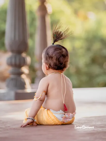 Peek-a-boo. Did someone say butter? Even the back of our little Krishna is adorable.