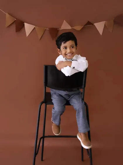 A charming smile from the birthday boy. These simple, classic portraits are a wonderful way to remember their personality at this age.