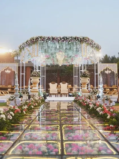 Your walk down the aisle should be nothing short of magical. We designed this breathtaking mandap with a glass floor over a bed of flowers, creating a pathway that feels like walking on a dream.