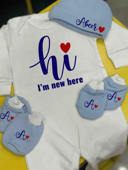 Welcome a new baby with this adorable personalized romper set. It comes with a cap and mittens, all customized with the baby's name or initial.