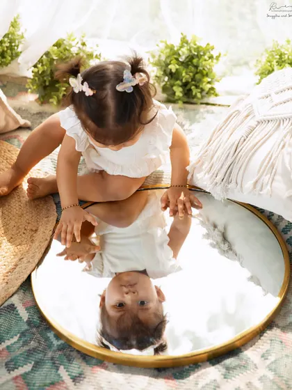 Who's that I see? Using a mirror outdoors creates such a magical and curious moment for a child's portrait.