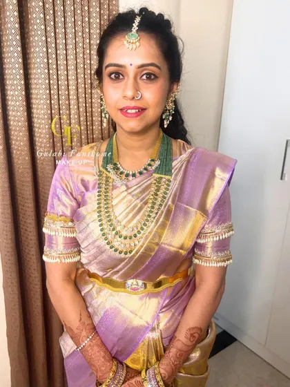 A full portrait showcasing the complete look. The makeup is understated, allowing her beautiful saree and jewelry to shine.