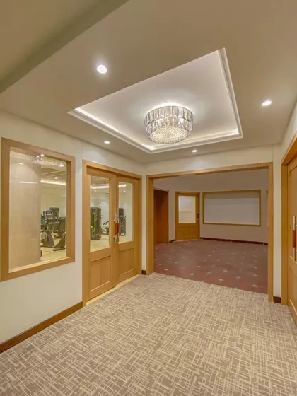 The corridor leading to the gym and other amenities in our Bhopal hotel project. We ensure that even transitional spaces are well-lit, clearly defined, and consistent with the hotel's overall design aesthetic.