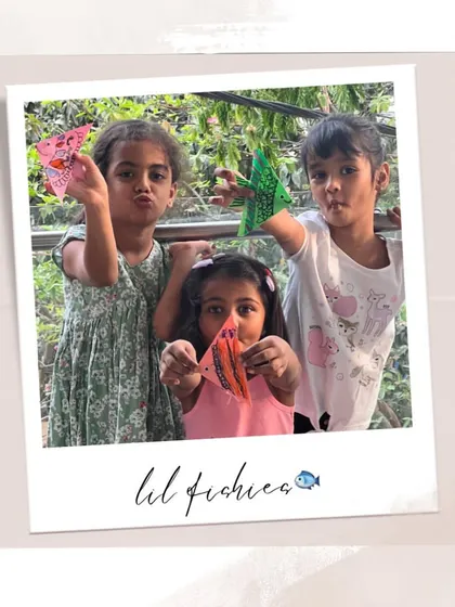 Our "lil fishies" posing with their colorful origami fish. They had so much fun decorating them with their own patterns.