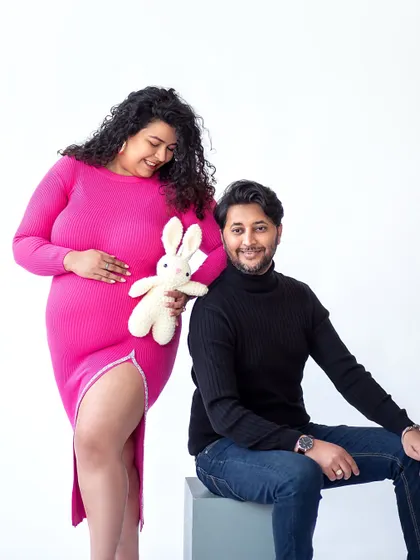 A playful and sweet moment with a stuffed bunny. This adds a touch of innocence and anticipation for the baby's arrival.