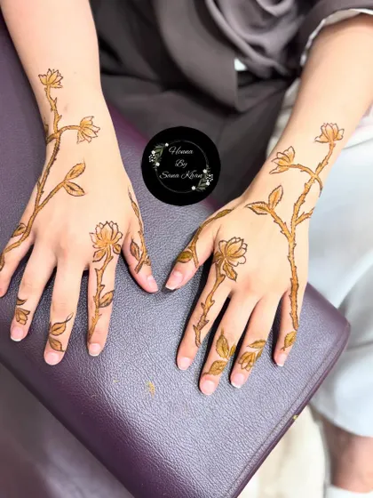 The completed floral vine design, showing how it looks on both hands. The pattern is light and airy, with plenty of open space.