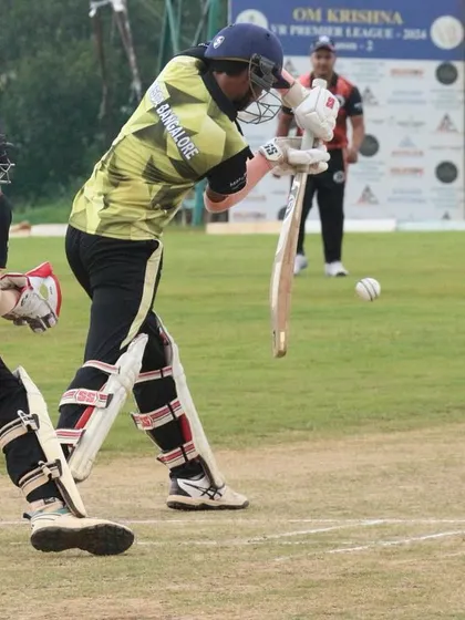 A batter plays a shot while the wicketkeeper looks on, during a Dasara Cup match.
