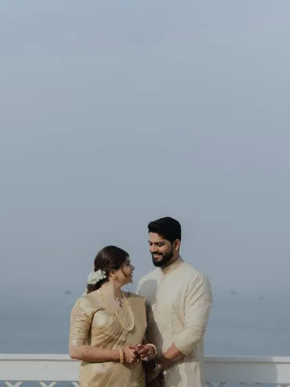 A romantic shot of the couple against the sea. My draping ensures the bride looks perfect from every angle.