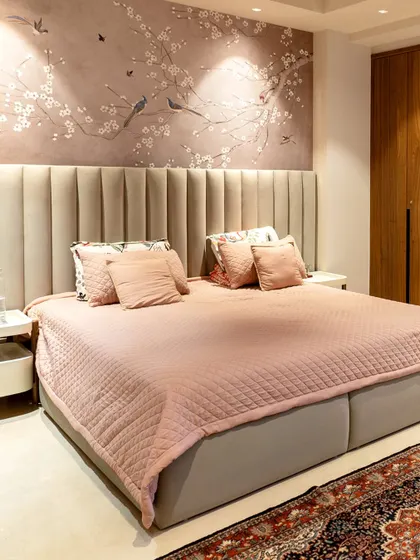 We designed this master bedroom to be a true sanctuary. The blush-toned bedding and vertically channeled headboard create a soft, inviting feel, while the bespoke cherry blossom wall mural adds a touch of serene, artistic elegance. It’s a space crafted not just for rest, but for complete restoration.