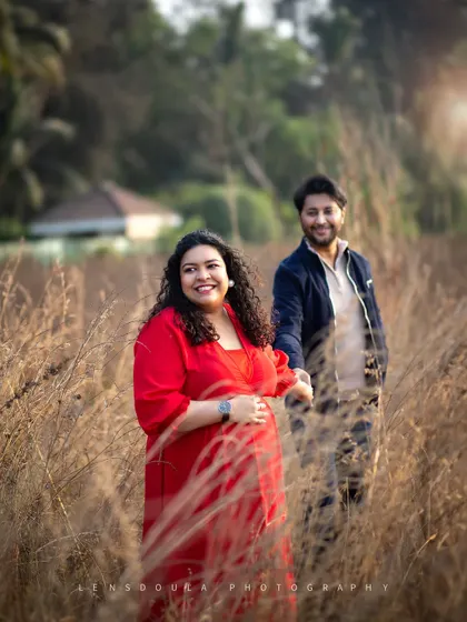 Leading the way into their next chapter. This shot in a field of tall grass has a beautiful, narrative quality, symbolizing their journey together.
