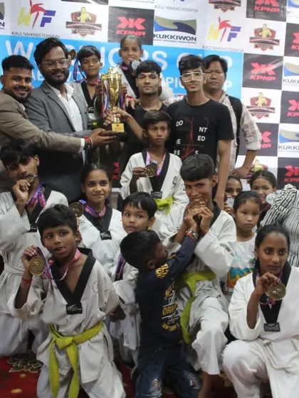 The joy of victory. A group of my Taekwondo students celebrating with their medals and the championship trophy.