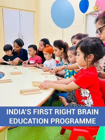 A group of children and their parents build with wooden blocks, an open-ended toy that encourages creativity, spatial reasoning, and collaborative play.