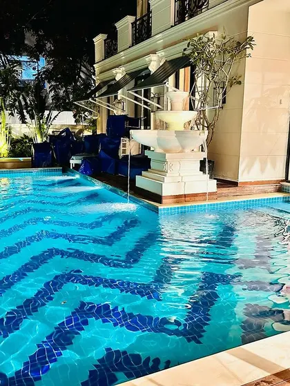 This shot captures the full effect of the pool, fountain, and house lighting working together to create a stunning outdoor entertainment area.