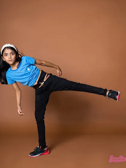 Another high-energy pose from the kids' fashion catalogue shoot. Action shots like this are great for showing that the clothes are made for play.