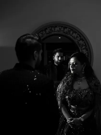 A creative portrait using reflections. The groom is seen in the mirror looking at his bride, adding a layer of depth and storytelling to the image.