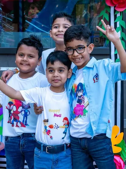 Pure joy and peace signs from a group of friends at our Holi event. The Playhouse is a place where friendships blossom.