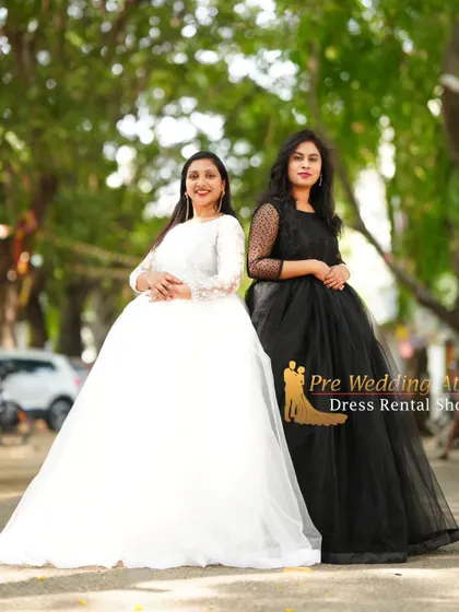 A full-length shot of two women in contrasting black and white ball gowns. This demonstrates how different styles from my collection can be coordinated for a group photoshoot.