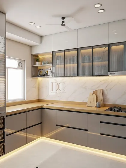 An L-shaped modular kitchen that makes the most of the available space. The design includes handle-less drawers, fluted glass cabinets, and a dedicated pantry unit with wicker baskets, combining modern looks with practical storage solutions.