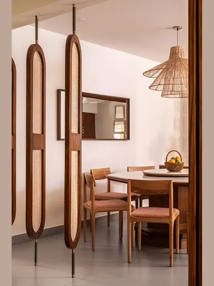 A view from the living room into the dining area, highlighting the custom-designed rotatable partition. This element provides privacy while maintaining the open and airy feel of the Japandi-inspired home.