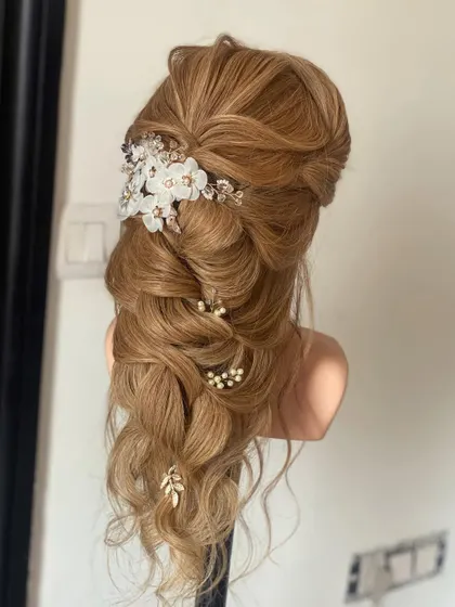 Practicing a romantic, whimsical hairdo on my mannequin. I'm always experimenting with new techniques and accessories to bring you the most beautiful styles.