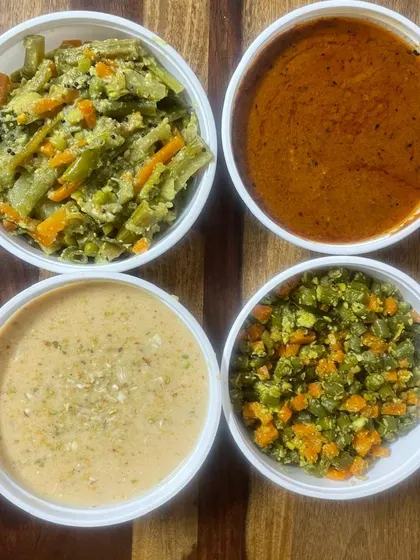 Vathal kulambu, carrot beans poriyal, vegetable aviyal and payasam are packed in separate tubs from our home kitchen.