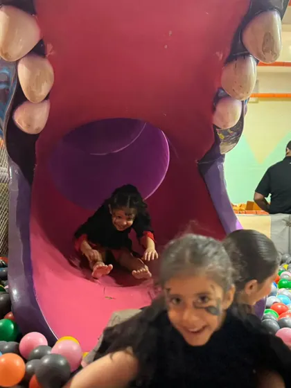 Whee! The play zone is open during all my events, so kids can slide, jump, and burn off all that party energy. These happy faces coming down the hippo slide say it all.