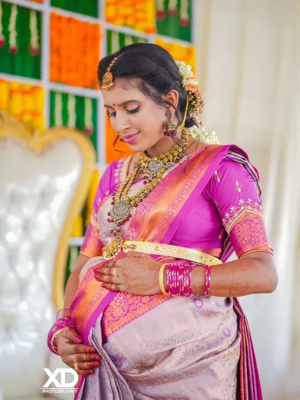 A close-up portrait capturing the mother-to-be's gentle expression as she cradles her baby bump during the ceremony.