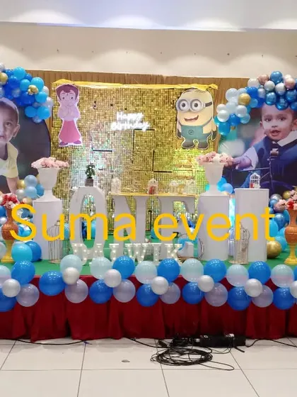 A personalized Minions theme that includes large photos of the birthday boy. This unique setup combines a gold shimmer wall with character cutouts and circular balloon frames for a memorable backdrop.