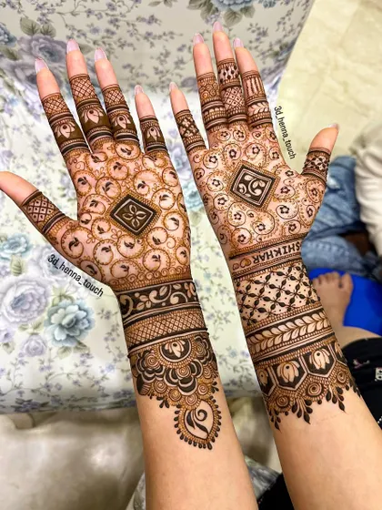 A sophisticated design featuring a central geometric pattern surrounded by delicate motifs. The name 'Shikhar' is beautifully integrated into the wristband design.