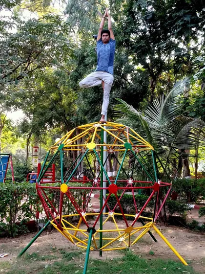 Performing Vrikshasana, the Tree Pose, on an unconventional surface challenges and refines our sense of balance. Yoga teaches us to find competence and poise not just on the mat, but in all aspects of life.