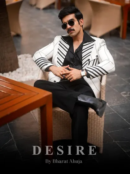 A look of pure confidence. The white pinstripe blazer, paired with a dark shirt and a confident posture, channels a timeless, powerful aesthetic.